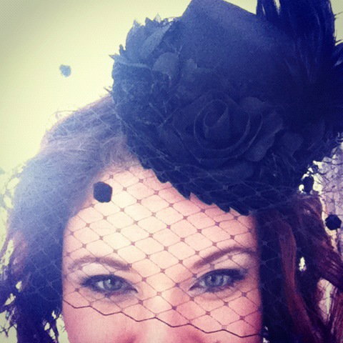 Fascinators and hair do-dads of all kind are welcome. This one belongs to photographer McConnell. Top that!