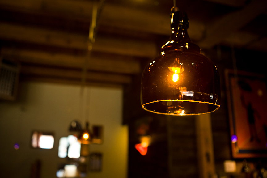 "We couldn’t afford to buy anything, so we just made everything we could," Liptak told photographer Lucas Anderson. Light fixtures include a growler cut in half.