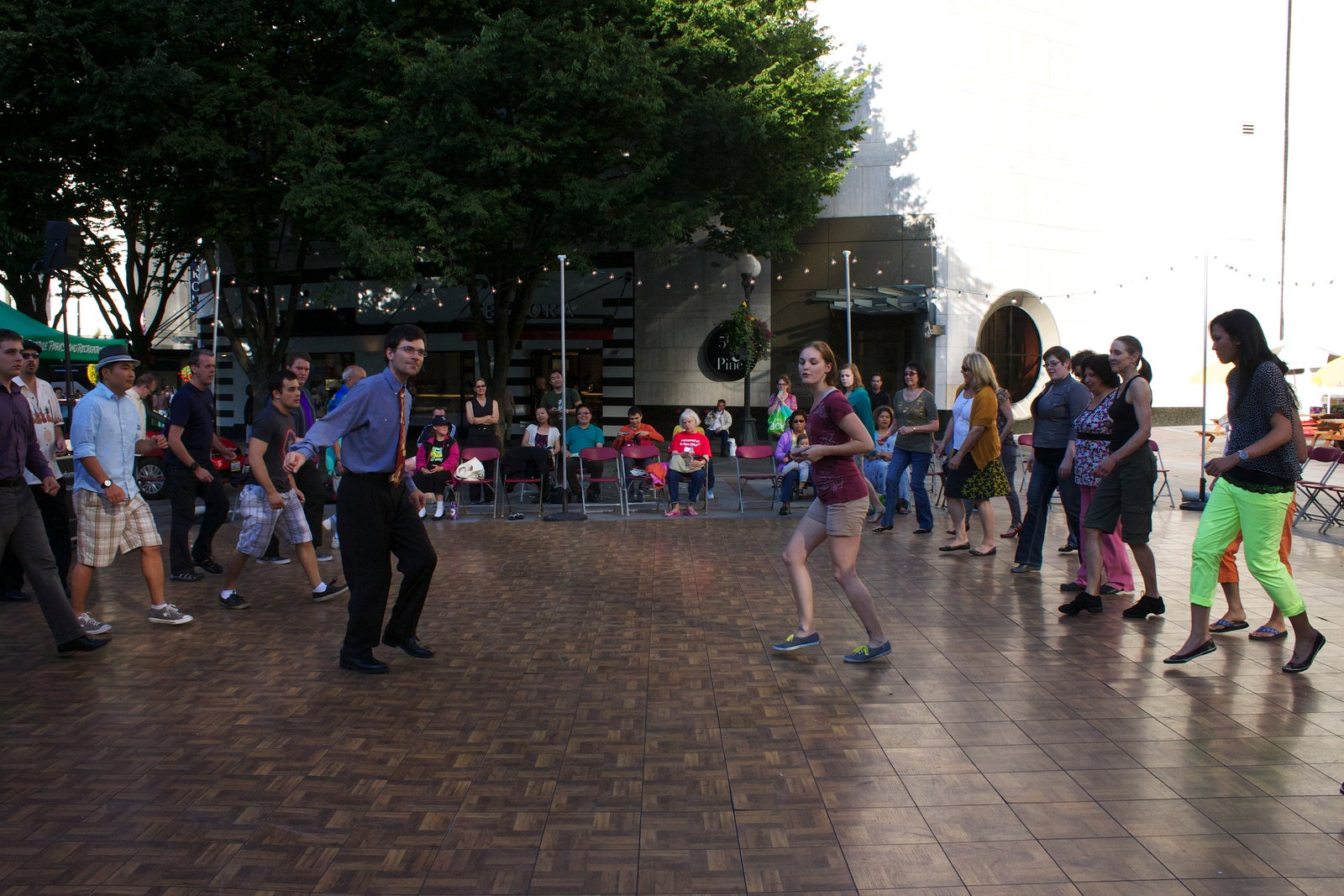 Douglas and Applegarth teach the crowd the basic Lindy Hop forward and backward triple steps.
