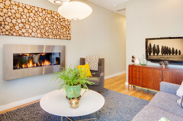 Warm texture abounds in the art, floor coverings, furniture, and even the houseplants.